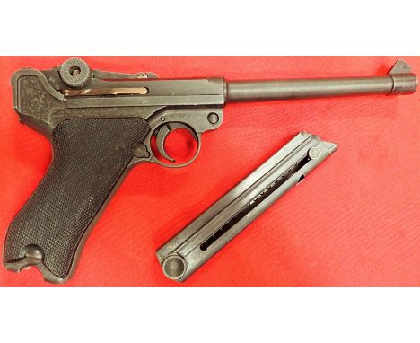 1970s vintage Japanese strippable replica WW2 German luger pistol. Features black chequered composite grips. Removable spring