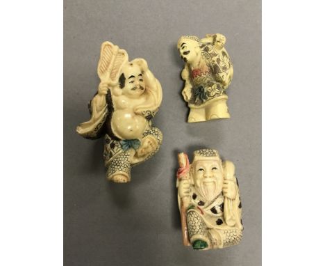Three Netsuke carvings including Traveller, Man laying with fan and Old man with Sack and Stake