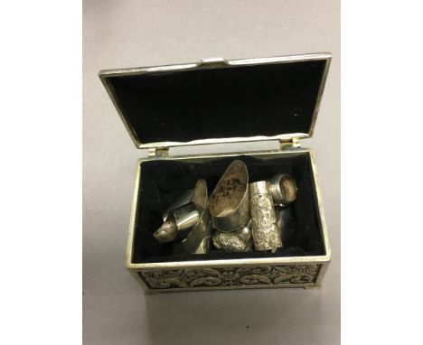 Nine silver walking stick caps with silver box