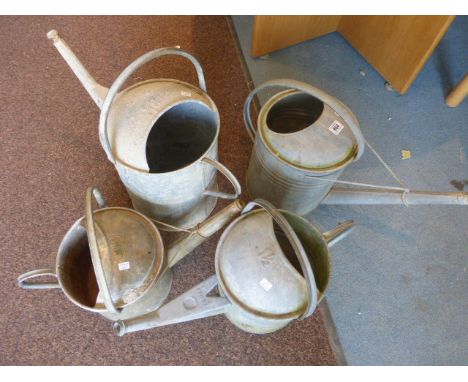 Four vintage metal watering cans