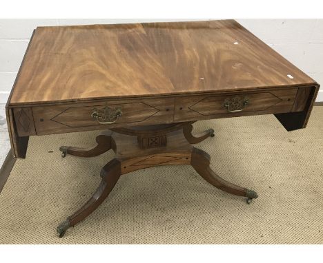 A mahogany and inlaid drop-leaf sofa table in the early 19th Century Scottish taste, with dot and line decoration, the top wi