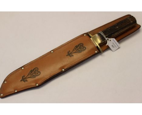 A Geo Wostenholm Bowie Knife with Horn grip and leather scabbard.