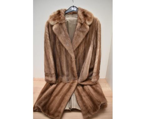 A honey toned vintage mink coat, having pockets to sides.