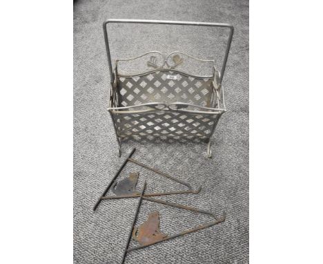 A vintage wrought iron magazine rack and two plant hangers having cat decoration.
