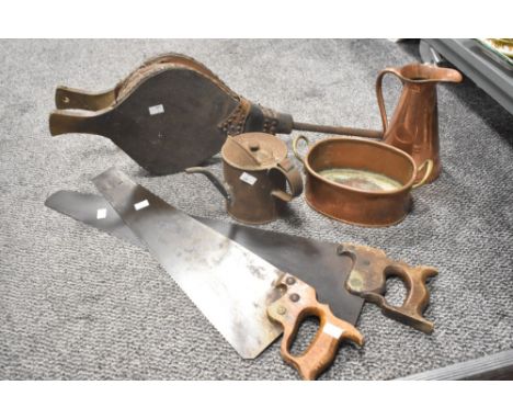 A pair of 19th/20th Century bellows, two vintage saws, and a small collection of copperware including a measure