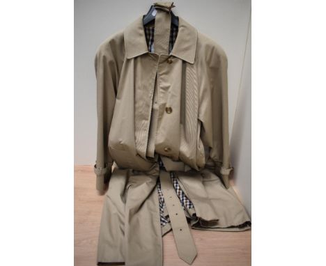 A vintage Ladies Aquascutum rain coat, having belt to waist and fully lined in checked fabric, medium size.
