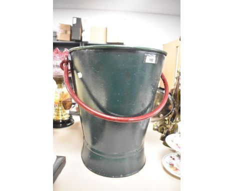 A large vintage iron bucket.