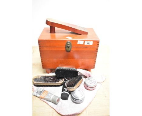 A vintage stained wood shoe cleaning box of dovetailed construction containing shoe shining products, measuring 28cm tall