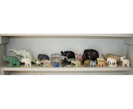  A collection of carved semi-precious and hard stone elephants, including examples in jade, rose quartz, rock crystal etc.; t