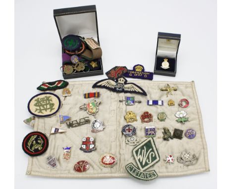  A collection of cloth and pin badges, some military,  some first half 20th century, including a WVS CI States cloth badge, a