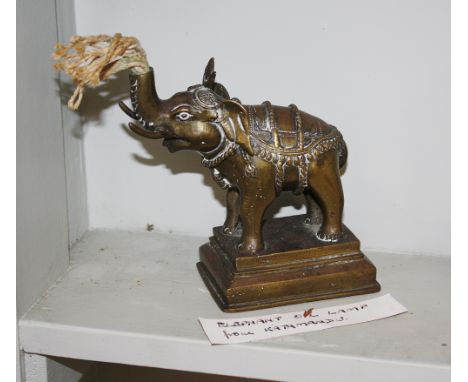  An Indian brass elephant oil lamp, early 20th century, finely adorned elephant with wick emanating from upturned trunk, on g