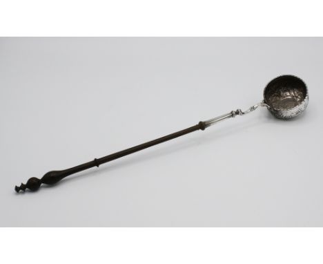  A 19th century silver toddy ladle, the bowl with repousse floral and foliate design, inset to base with a George II 1758 shi