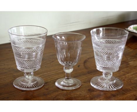 A pair of late Georgian cut glass rummers, the bucket bowls with comb, diamond and prismatic cutting, on short facet knopped 