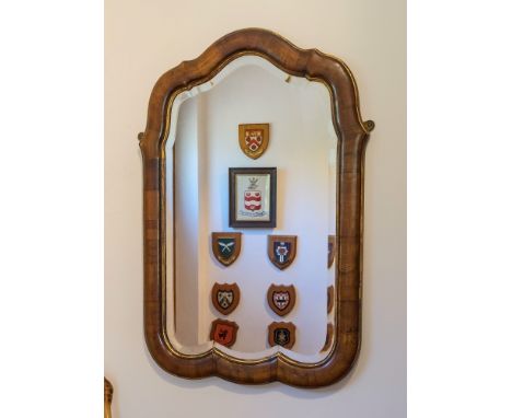  A Queen Anne style walnut mirror, Victorian, the shaped cushion frame with gilt borders, around the original bevelled plate,
