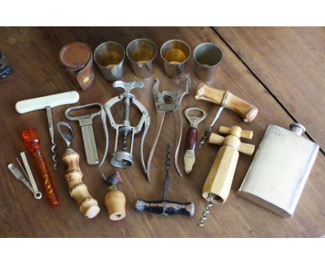 A collection of corkscrews and bottle openers, plus a leather cased set of nested shot measures, a silver plated spirit flask