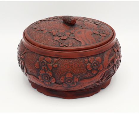  A Chinese cinnabar lacquer pot and cover, early 20th century, of bun form, decorated with flowering prunus branches, domed c