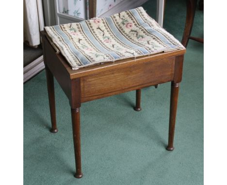  A Edwardian mahogany piano stool, with rectangular hinged seat, on cylindrical supports with compressed ball feet, 18 x 14in