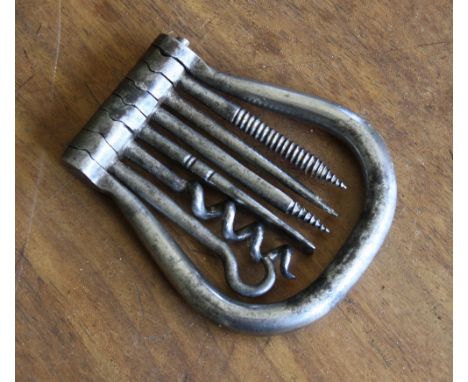 A polished steel military multi tool, probably WW1 period, the U-shaped handle enclosing a snap-hinged set of six tools inc. 