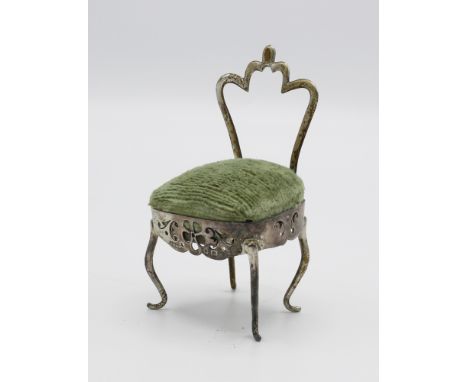  An Edwardian novelty silver pin cushion, Ridley Brothers & Merton, Birmingham 1905, in the form of a crown backed chair, pie