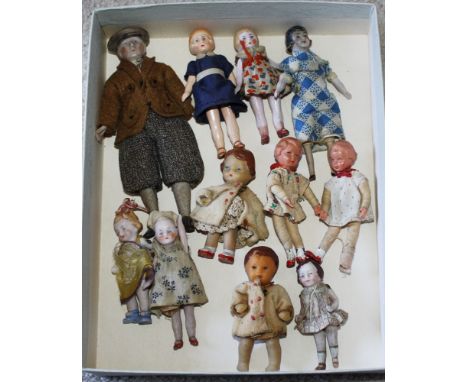  A small collection of dolls house dolls, early 20th century, to include a bisque headed country gent in plus fours and cap, 