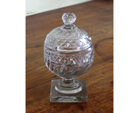 A Georgian cut glass sucrier and cover, globular form, with wave and diamond cut decoration, on square base, 17.8cm. high. 