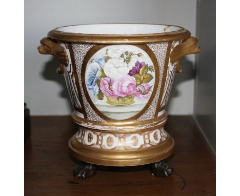  An early 19th century Spode cachepot and stand,  with beast handles and paw feet, decorated with a basket of flowers to one 