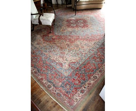  A large American Sarouk rug, early 20th century, the four pointed central medallion on a light blue floral ground, within a 