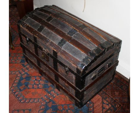  A good 19th century leather over wood cabin trunk,  with horizontal coopered wood strapping, domed hinged lid, centralised l