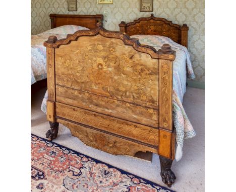 An impressive Dutch walnut and marquetry single bed, 19th century, the head and foot boards with shaped arched tops and squar