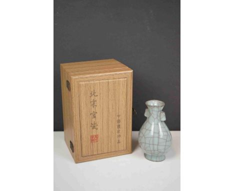 A Chinese ceramic vase in original wooden case.