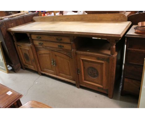 Late 19th century Arts and Crafts influence Oak Sideboard, the two central drawers flanked either side by two open shelves, o
