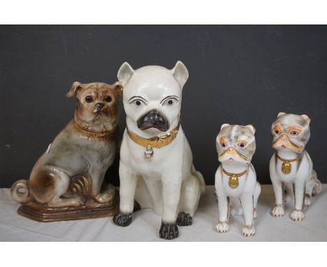 A pair of Sutherland ceramic pug dog figures and two other pug dog figures. 