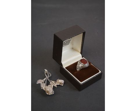 Gentleman's Silver Ring set with an Oval Carnelian together with a Sterling Silver Brooch in the form of Flowers, 6cms high 