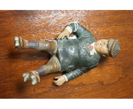 A Humorous ceramic figure of  a man 1930s possibly Billy Bunter impressed 7061 BB  together with a continental table top flow