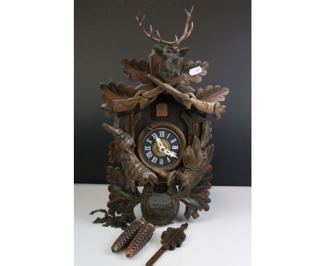 A contemporary German cuckoo clock with Rabbit and Woodpecker decoration. 