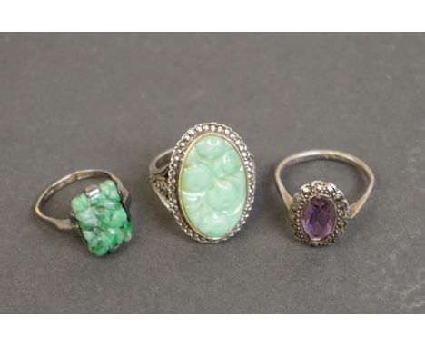 Three silver rings comprising circa 1920s jade ring, a jade and marcasite dress ring, together with a circa 1930s amethyst an