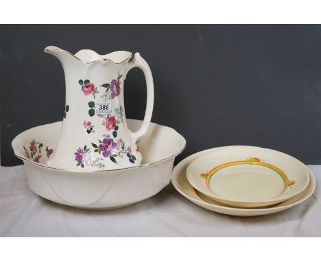 A vintage ceramic wash basin and jug together with two Clarice Cliff Bizarre pattern platters. 