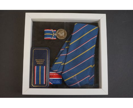 A framed National service medal and tie. 