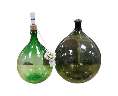 Two green glass carboys, one converted to a lamp, 58cm high overall. Condition - good, untested