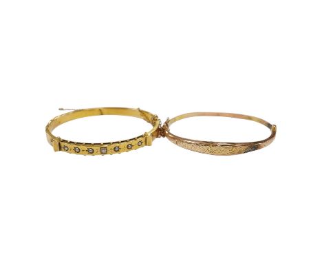 An Edwardian yellow metal, diamond and seed pearl set hinged bangle and one other late Victorian engraved 9ct gold hinged ban
