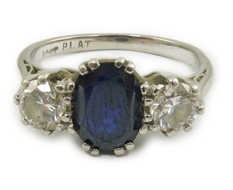 An 18ct white gold and platinum, single stone oval cut sapphire and two stone round cut diamond set ring, size J/K, gross wei