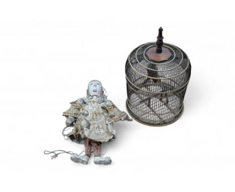 A Thai painted wood puppet, with sequined fabric costume and a wire and rattan circular bird cage, 65cm. Condition - fair