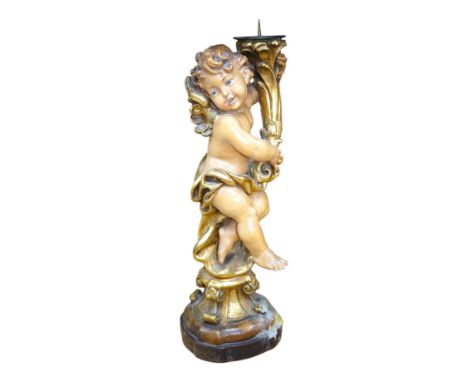 An Austrian carved and partially gilt cherub pricket candlestick, 37cm high. Condition - fair to good