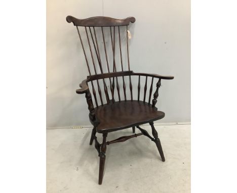 A 20th century American Windsor beech comb back armchair, width 73cm, depth 51cm, height  113cm. Condition - fair