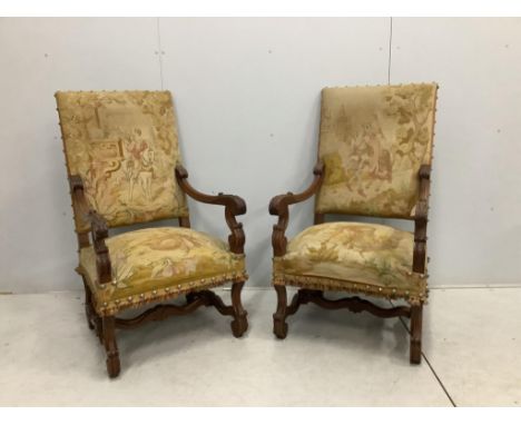 A pair of 18th century style walnut and needlepoint tapestry chairs, width 63cm, depth 64cm, height 114cm. Condition - fair