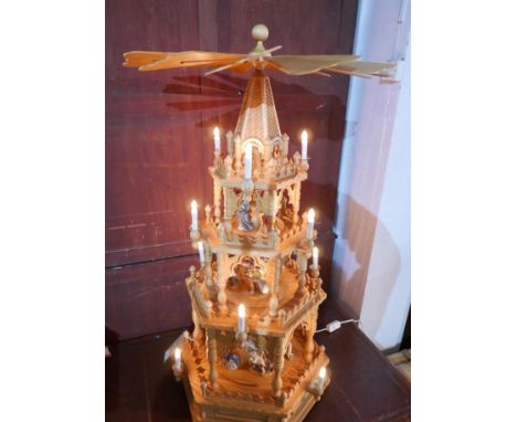 An Eastern German Christmas pyramid, with Navity scenes including, figures, animals and angels revolving in each tier, with r