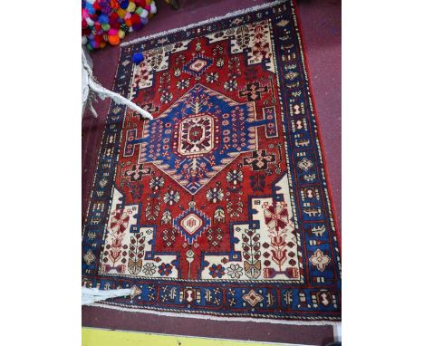 A North West Persian Nahawand rug, central diamond medallion with repeating petal motifs on a terracotta field, within stylis