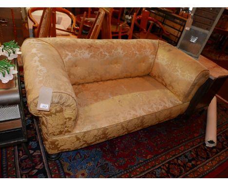 An early 20th century Chesterfield sofa with floral damask upholstery, raised on turned legs and castors 