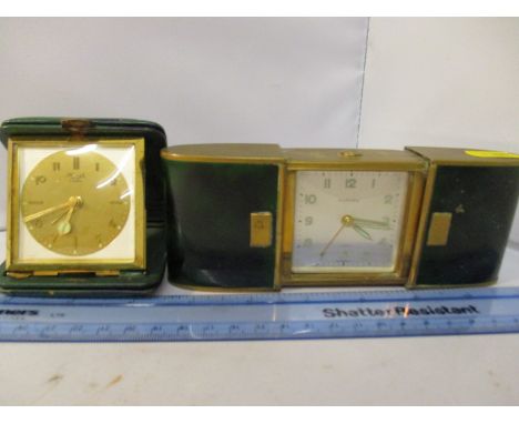 2 Retro Alarm Clocks. A green faux marble effect Europa 7 Jewels sliding travel wind up alarm clock and a vintage kienzle tra
