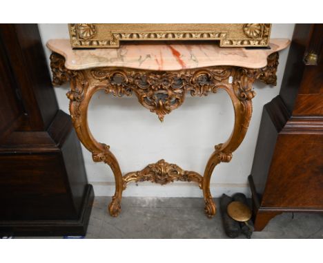 A Continental console table with serpentine marble top on carved and gilded base 